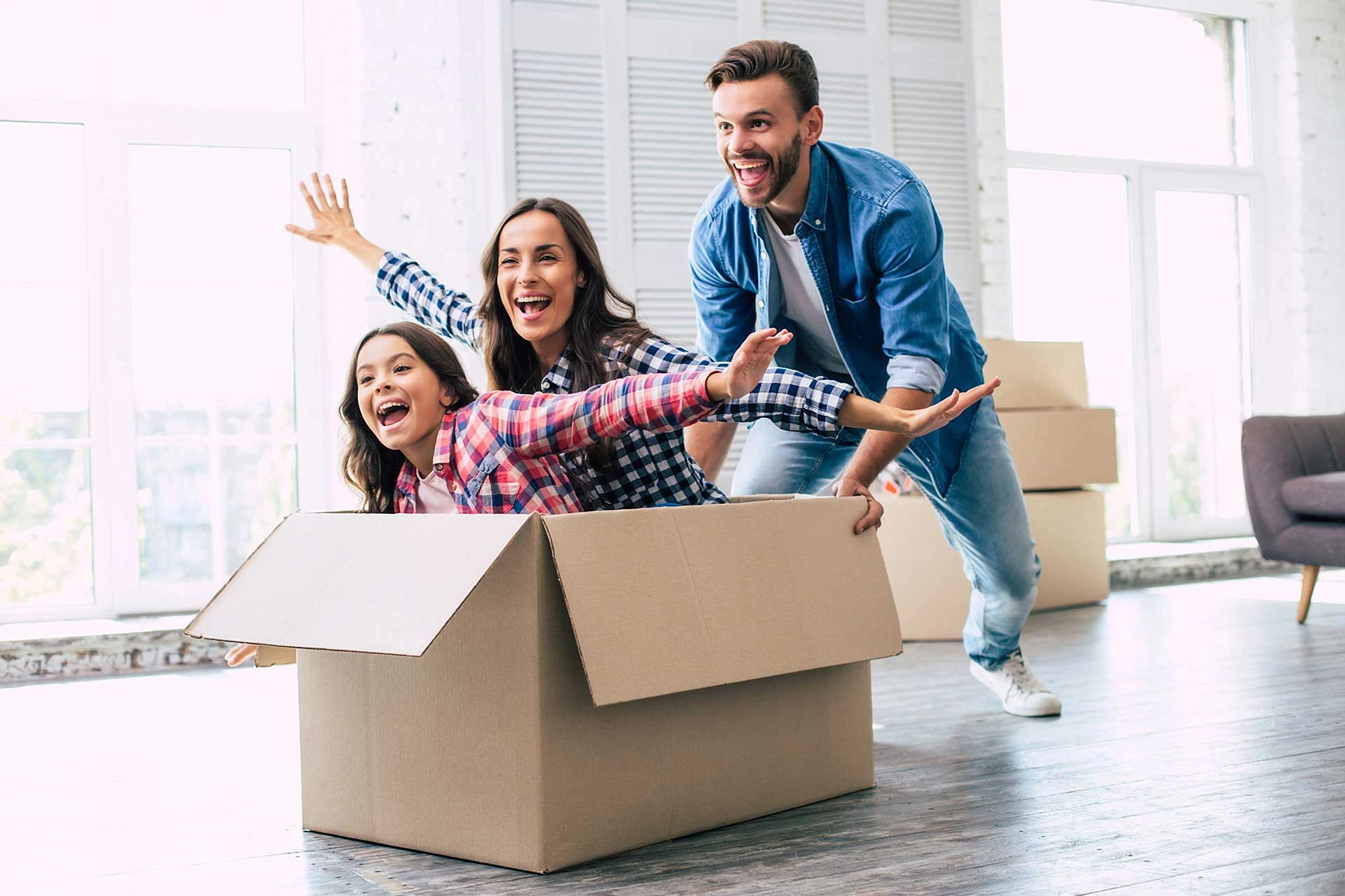 a family of four joyfully plays together inside a moving box sharing laughter and fun moments